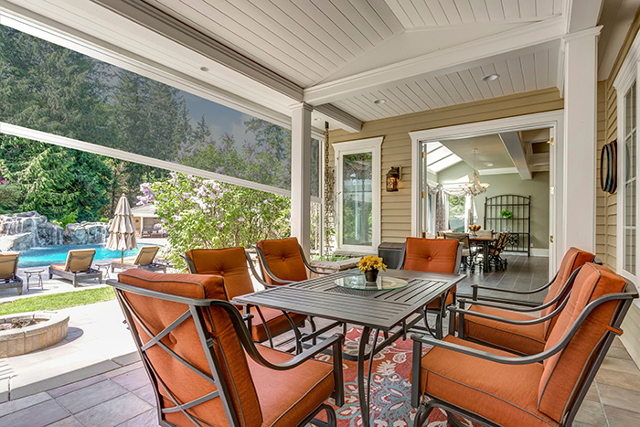 Outdoor covered patio with a retractable screen lowered halfway